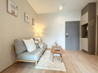 Chic modern living room with cozy sofa and stylish decor in a contemporary apartment.