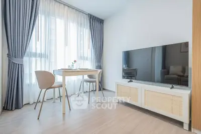 Modern living room with sleek TV stand and elegant dining area, featuring floor-to-ceiling windows and stylish curtains.