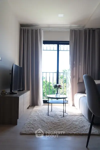 Modern living room with large window and stylish decor, offering a cozy and inviting atmosphere.