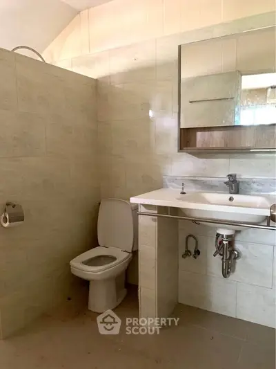 Spacious bathroom with modern fixtures and elegant tile design
