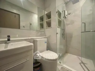 Modern bathroom with glass shower and sleek fixtures