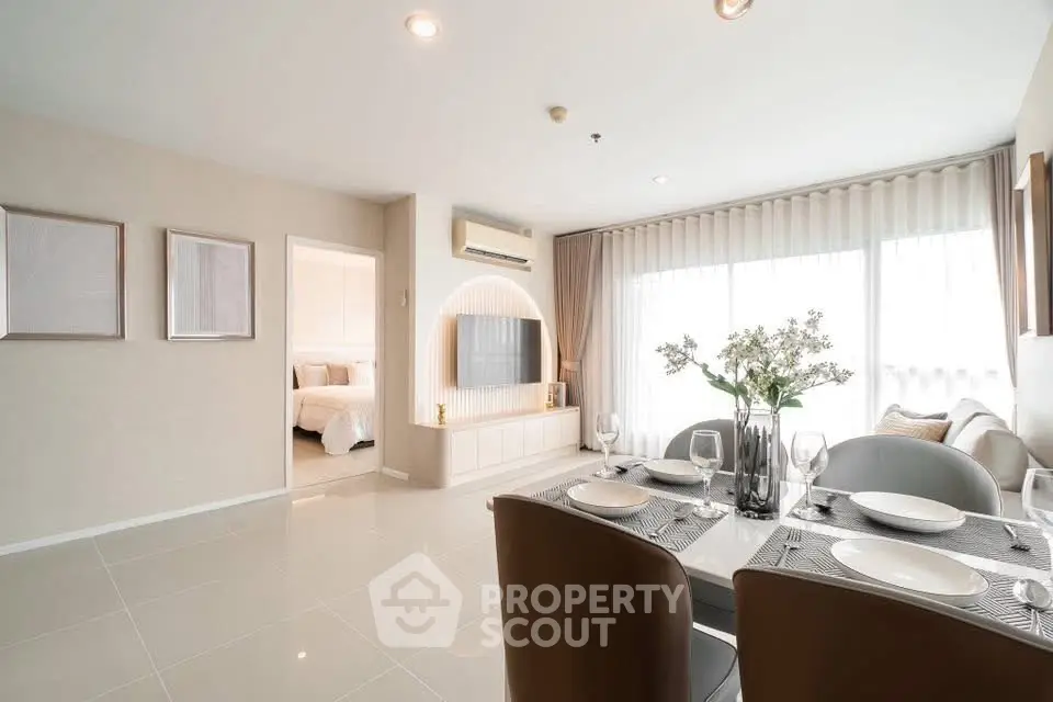 Modern open-plan living and dining area with elegant decor and natural light.