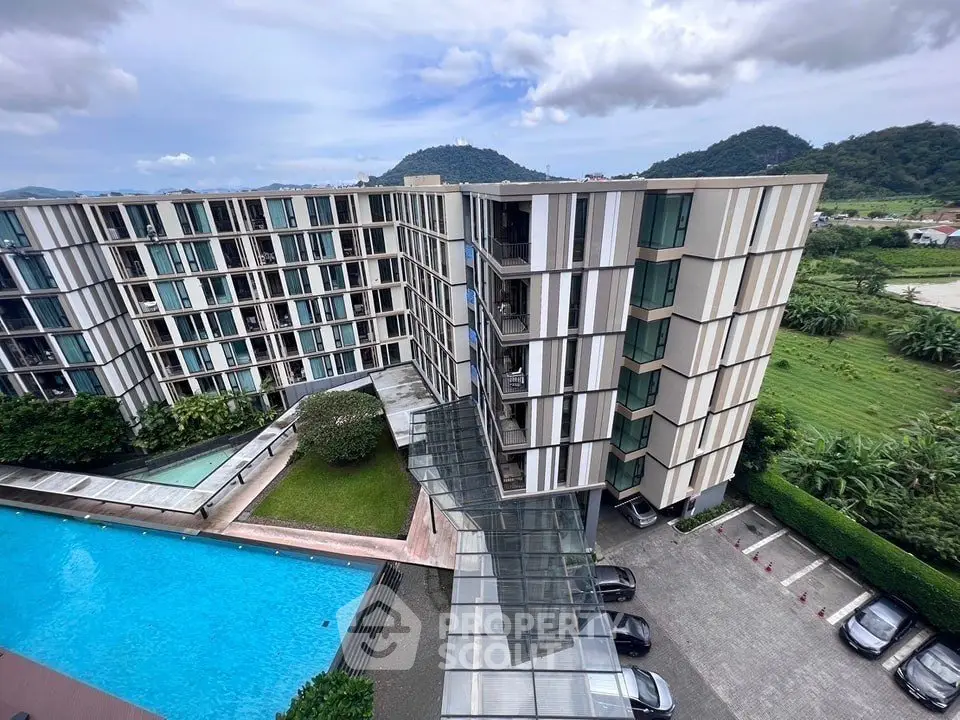 Modern apartment building with pool and scenic mountain views