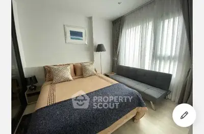 Cozy bedroom with modern decor and natural light from large windows