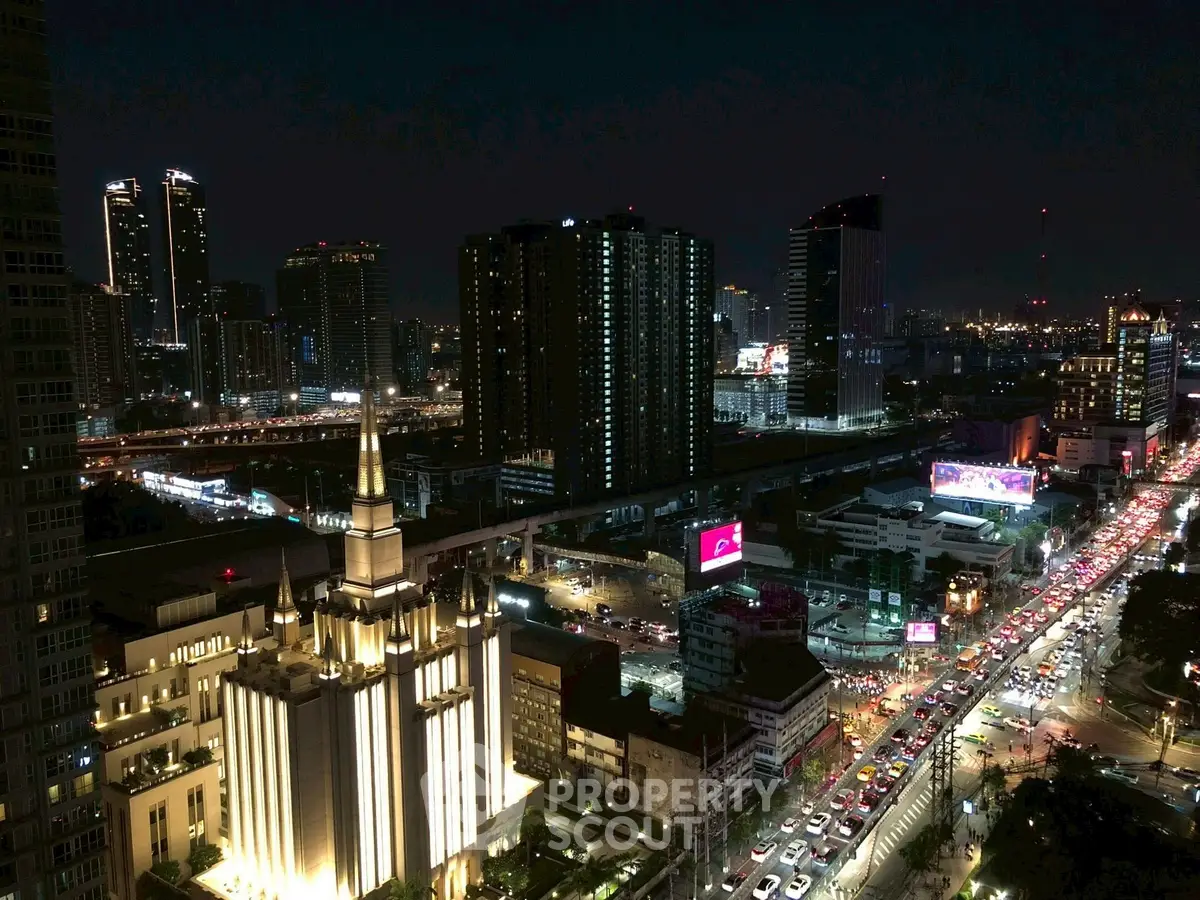 Stunning cityscape view with illuminated buildings and bustling streets at night.