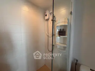 Modern bathroom with sleek shower and water heater in a minimalist design.
