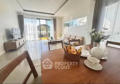 Bright and spacious living room with modern decor and garden view, perfect for relaxation and entertaining.