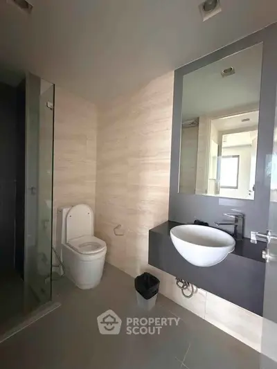 Modern bathroom with sleek fixtures and glass shower enclosure