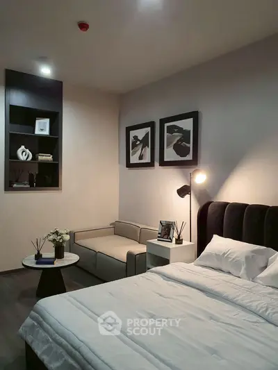 Modern bedroom with cozy seating area and stylish decor