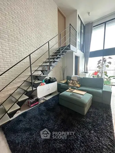 Modern loft living room with stylish staircase and cozy seating area