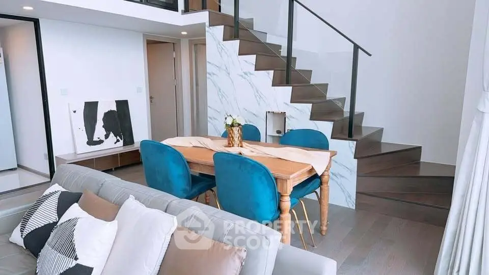 Modern duplex living room with stylish staircase and elegant dining area