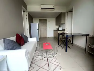 Modern living room with sleek furniture and open kitchen layout