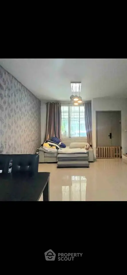 Spacious living room with modern decor and ample natural light