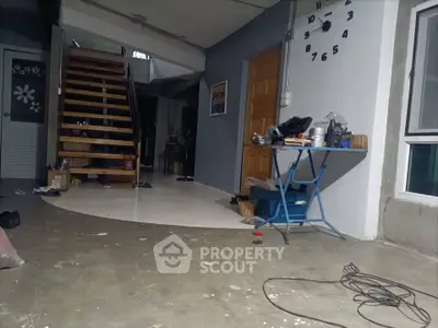 Spacious interior with modern staircase and work area, ideal for creative living.