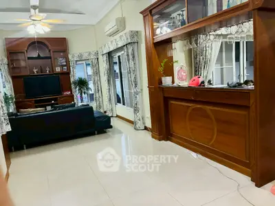 Spacious living room with elegant wooden cabinetry and large windows