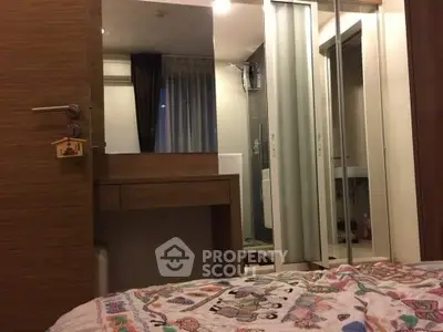 Cozy bedroom with mirrored closet and wooden accents in modern apartment.