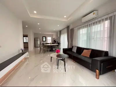 Spacious modern living room with sleek design and abundant natural light.