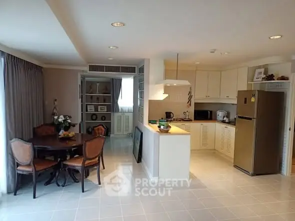 Spacious kitchen and dining area with modern appliances and elegant decor.