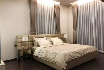 Luxurious bedroom with elegant decor and soft lighting, featuring a plush bed and stylish curtains.