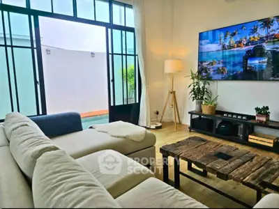 Stylish living room with modern decor, large windows, and cozy seating area.