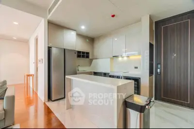 Modern kitchen with sleek design, stainless steel appliances, and marble countertops in a stylish apartment.
