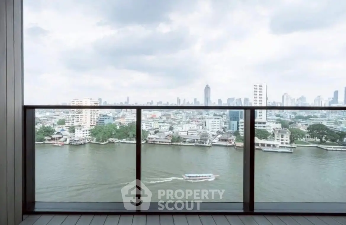 Stunning river view from a high-rise balcony in a modern cityscape.