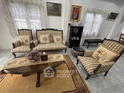 Charming living room with vintage furniture and floral decor, perfect for cozy gatherings.