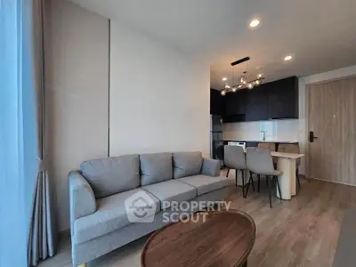 Modern living room with stylish furniture and open kitchen layout