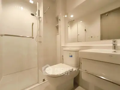Modern bathroom with sleek shower and elegant fixtures in a contemporary apartment.