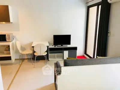 Modern living room with sleek furniture and balcony access