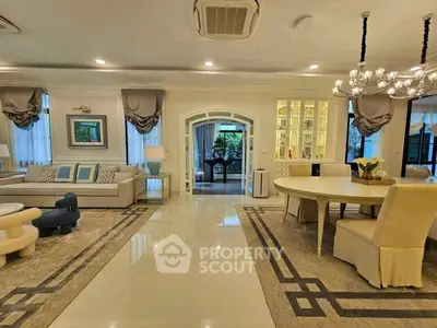 Luxurious open-plan living room with elegant decor and spacious dining area