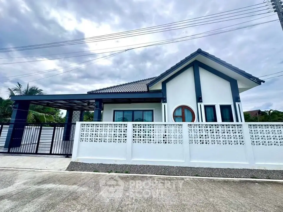 Charming modern house with unique circular window and spacious driveway in serene neighborhood.