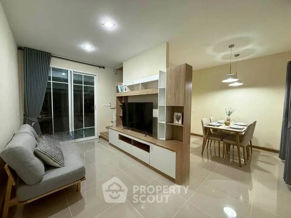 Modern living room with stylish furniture and open dining area