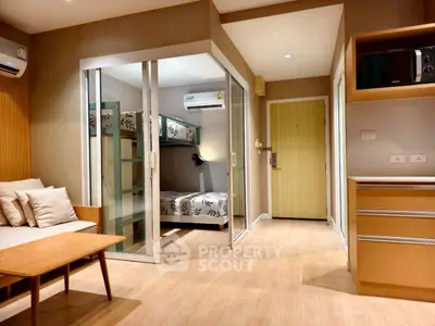 Modern studio apartment with cozy living area and stylish bunk bed setup.
