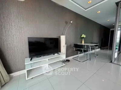Modern living room with sleek TV stand and dining area, featuring elegant decor and glossy tiled flooring.