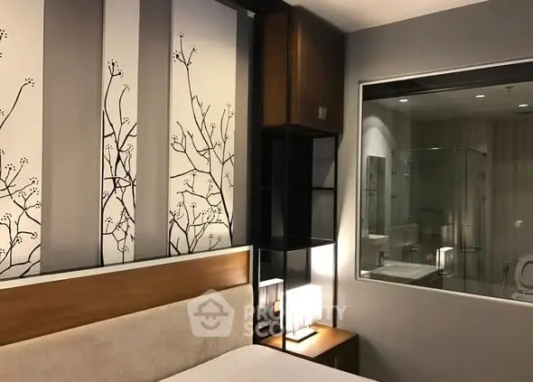 Modern bedroom with stylish decor and glass-walled bathroom for a luxurious living experience.