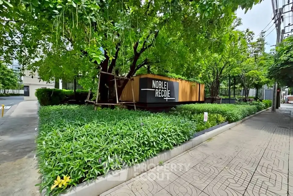 Lush green garden entrance of modern residential building