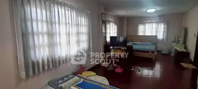 Spacious bedroom with natural light and cozy furnishings