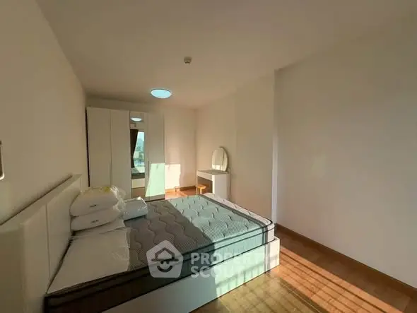 Spacious bedroom with modern furnishings and ample natural light