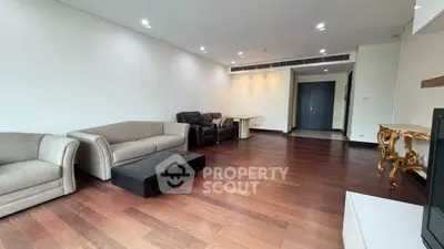 Spacious living room with elegant hardwood floors and modern furniture