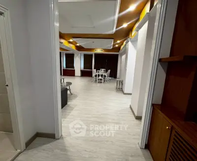 Spacious open-plan living area with modern decor and wooden accents.