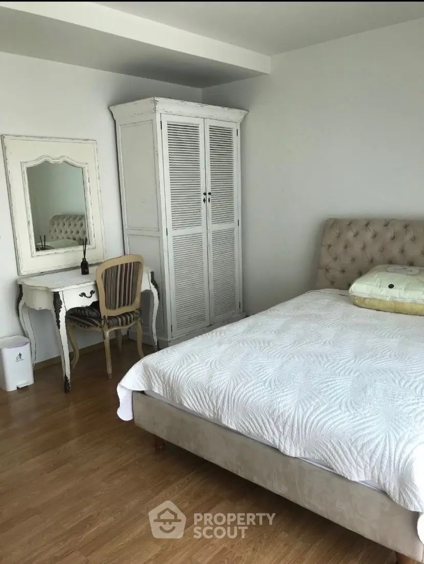 Charming bedroom with vintage furniture and cozy bed in elegant apartment.