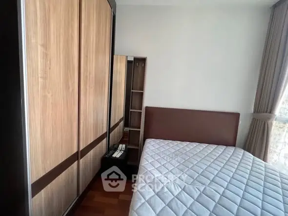 Spacious bedroom with large wardrobe and natural light