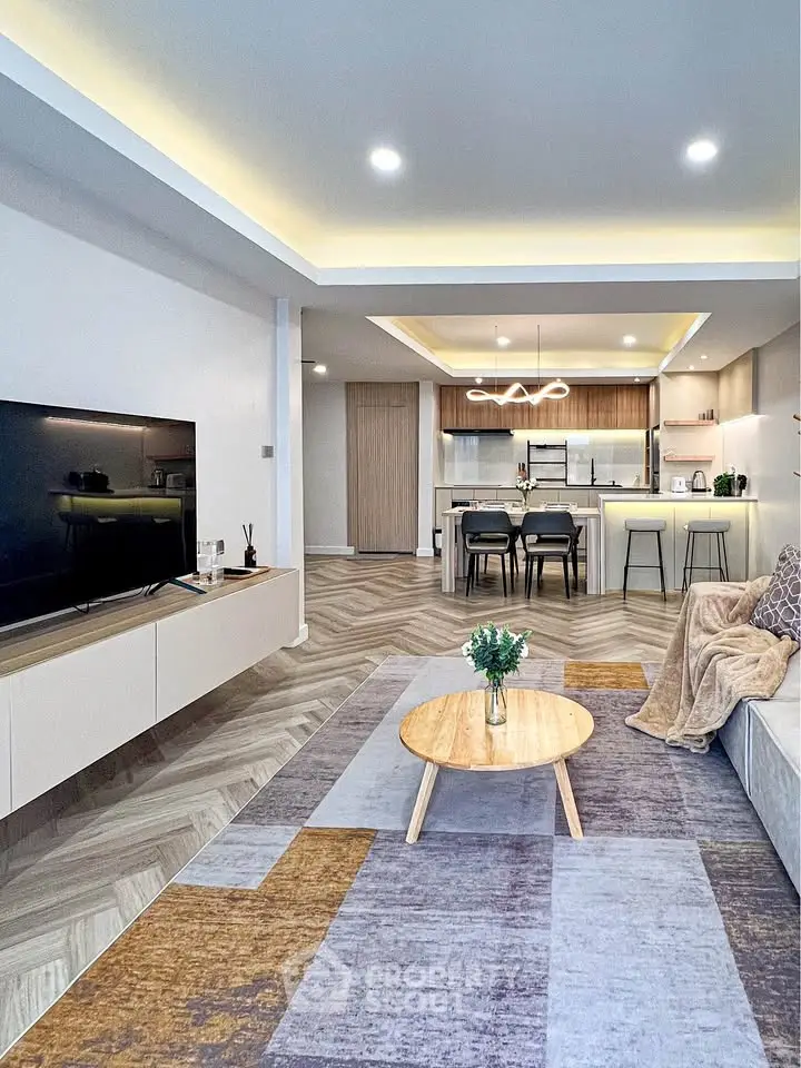 Modern open-plan living room with stylish kitchen and cozy decor