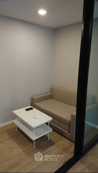 Cozy small living room with beige sofa and modern white coffee table
