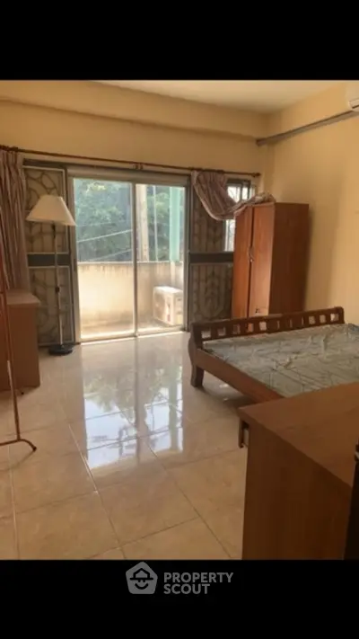 Spacious bedroom with balcony access and natural light