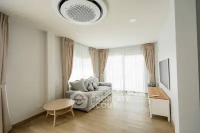 Spacious modern living room with large windows and elegant decor