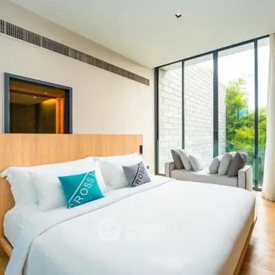 Luxurious bedroom with large windows and modern decor