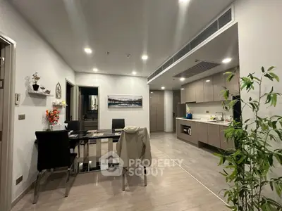 Modern open-layout kitchen and dining area with sleek cabinetry and stylish decor.