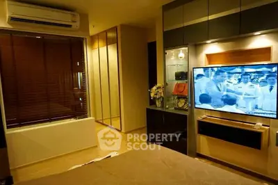Modern living room with air conditioning and flat-screen TV in stylish apartment.